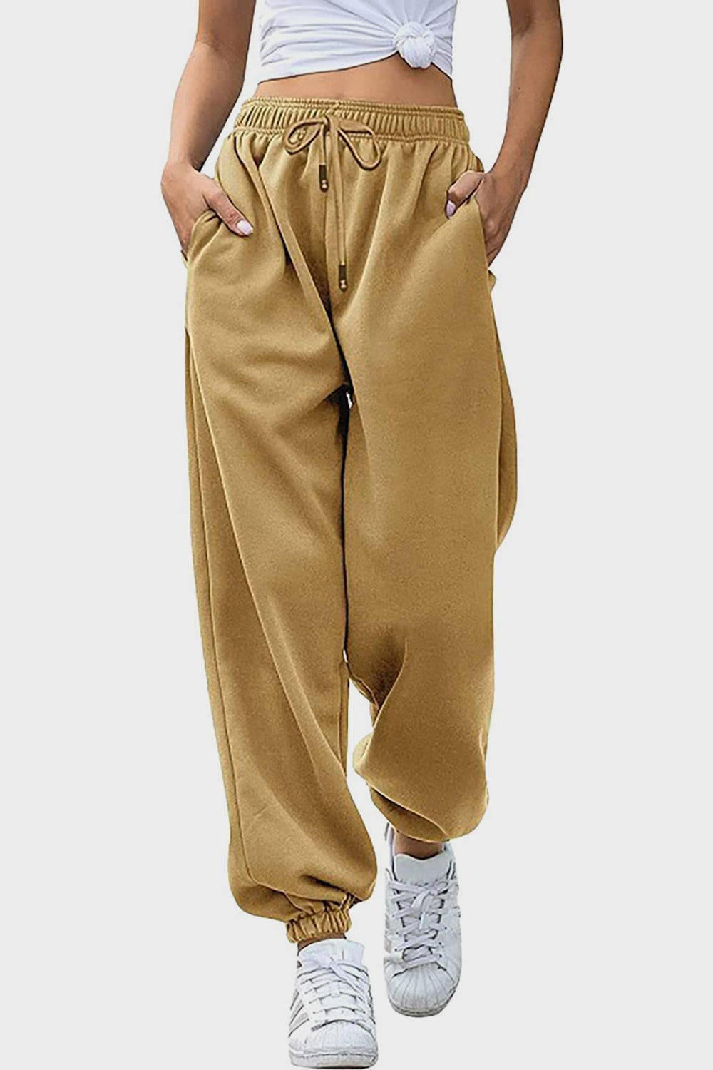 Elastic waist joggers with tie and pockets, opaque.