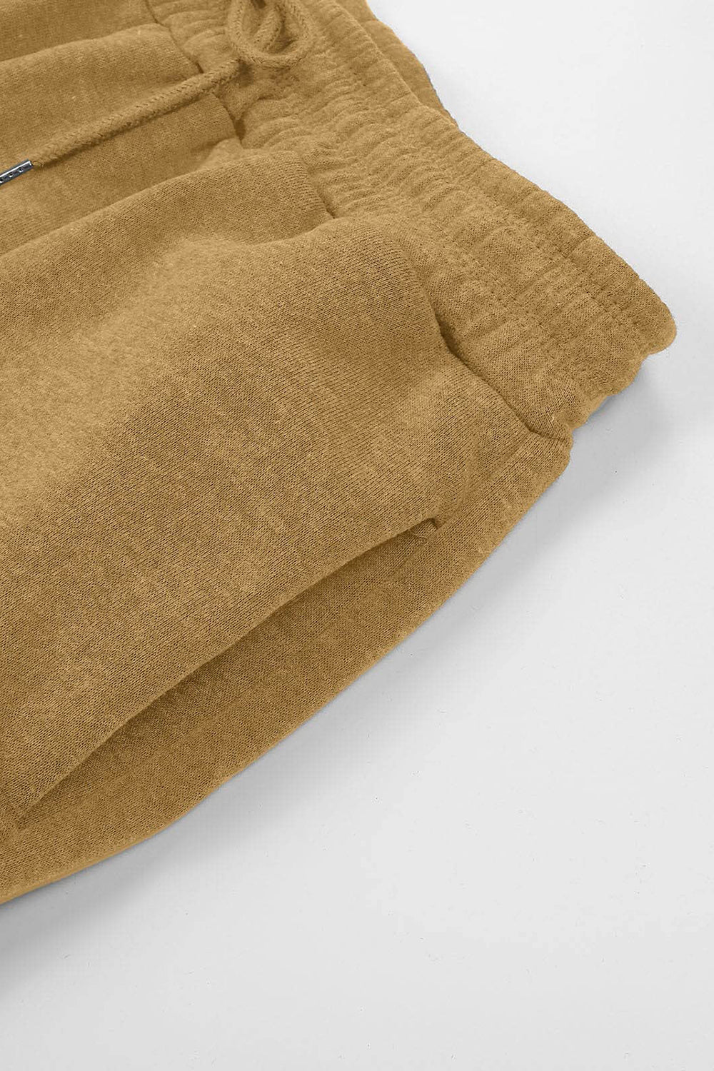 Elastic waist joggers with tie and pockets, opaque.