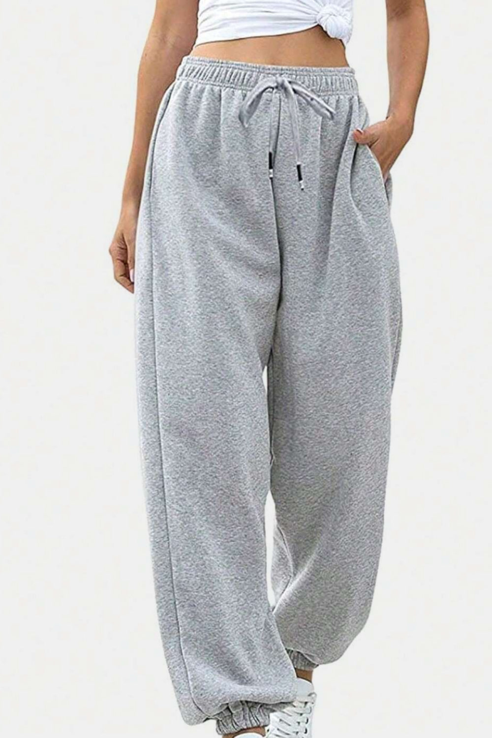 Elastic waist joggers with tie and pockets, opaque.