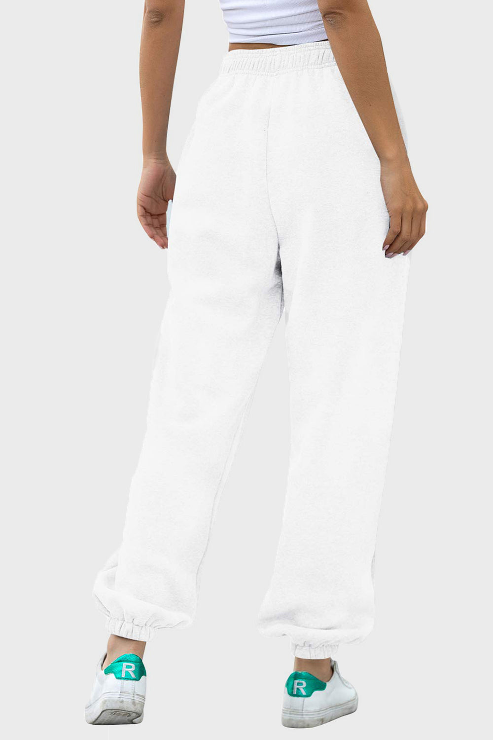 Elastic waist joggers with tie and pockets, opaque.