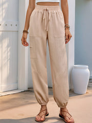 Elastic waist joggers with drawstring and pockets, opaque.