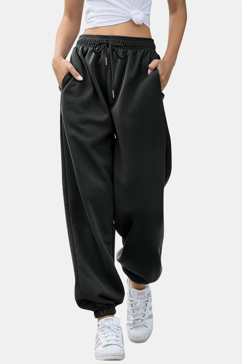 Elastic waist joggers with tie and pockets, opaque.