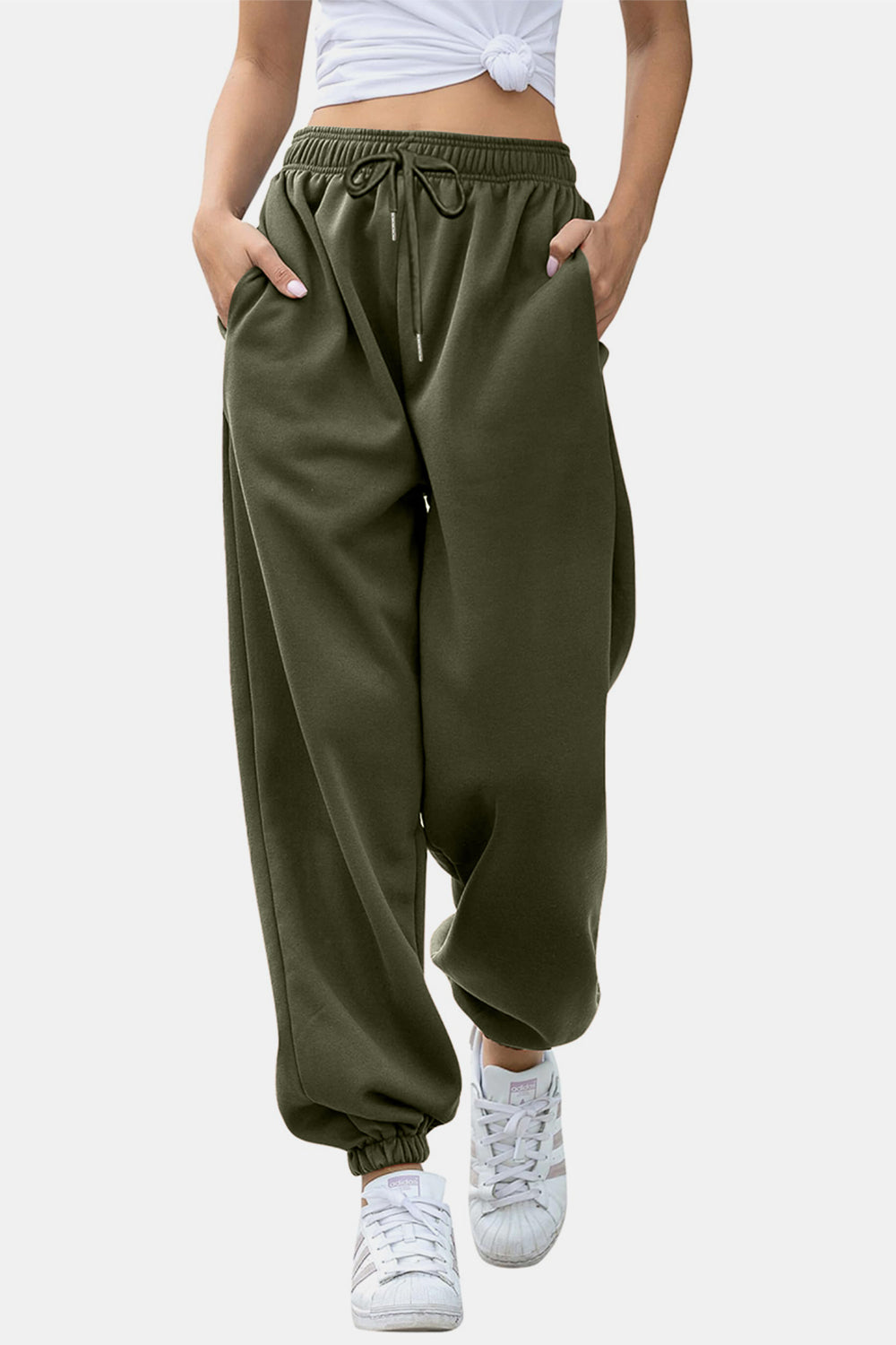 Elastic waist joggers with tie and pockets, opaque.