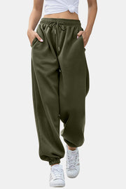Elastic waist joggers with tie and pockets, opaque.