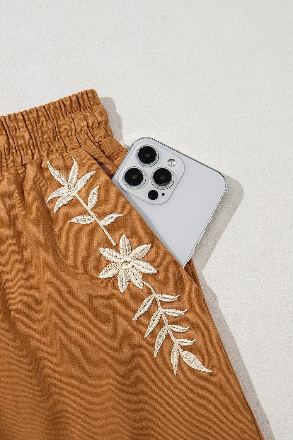 Embroidered boho tasseled drawstring elastic waist casual shorts.