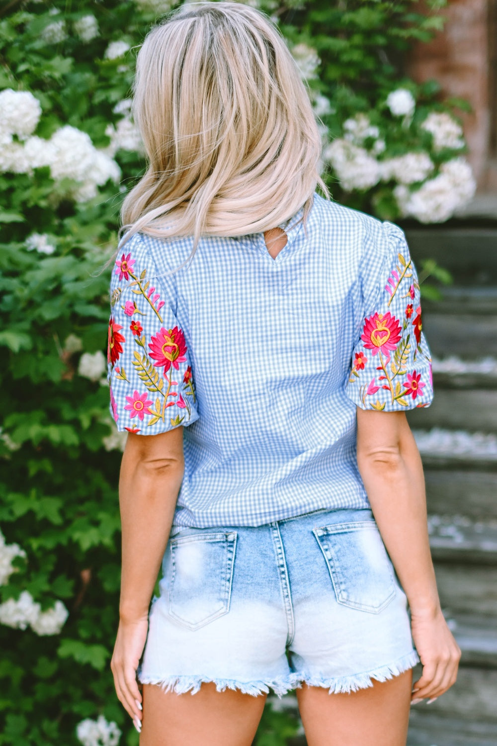 Embroidered plaid round neck short sleeve blouse.