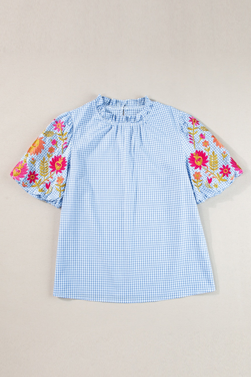Embroidered plaid round neck short sleeve blouse.
