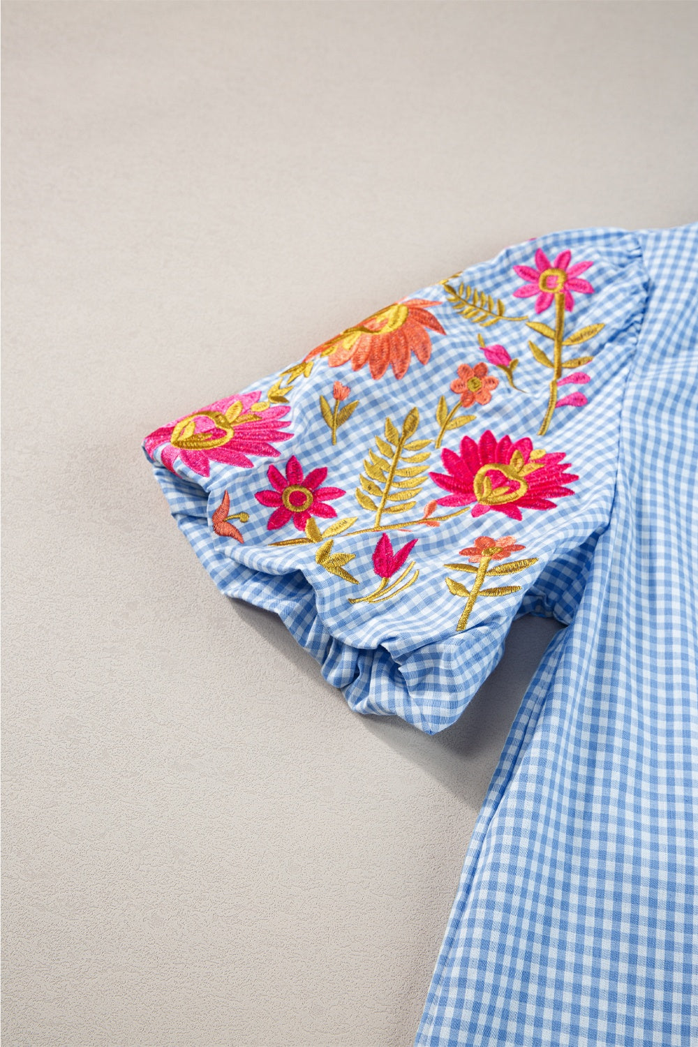 Embroidered plaid round neck short sleeve blouse.