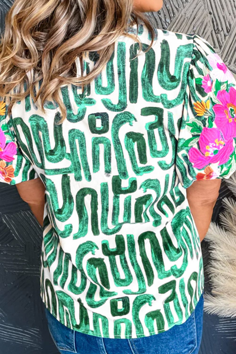 Embroidered printed mock neck short sleeve blouse.