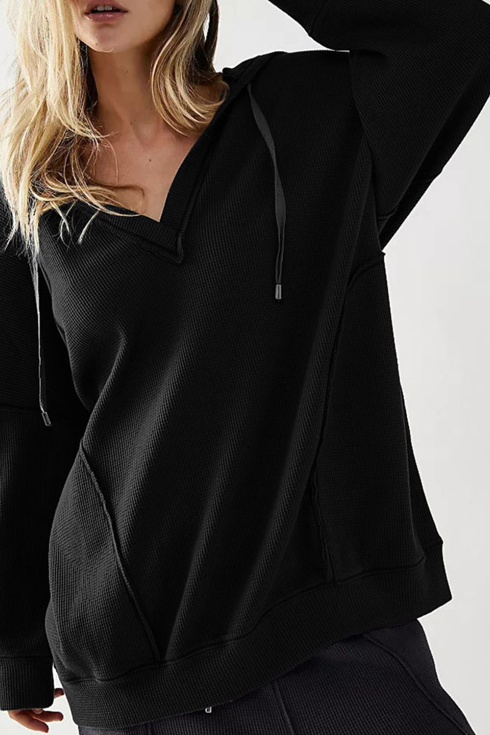Exposed seam drawstring long sleeve hoodie.