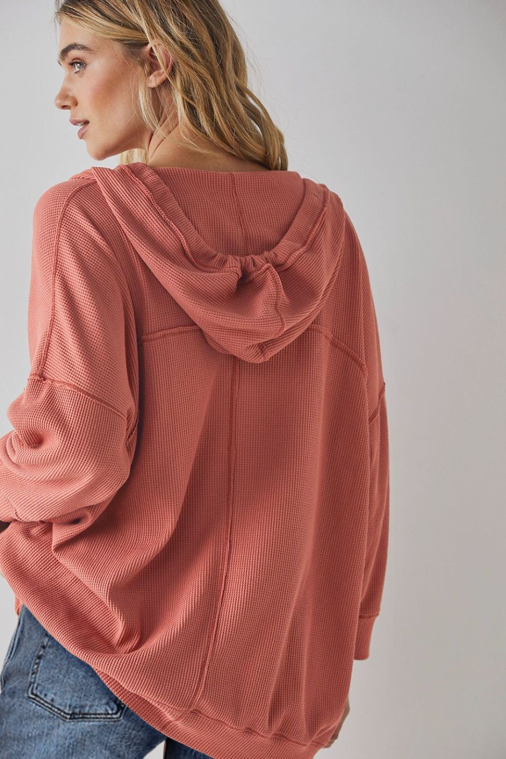 Exposed seam drawstring long sleeve hoodie.