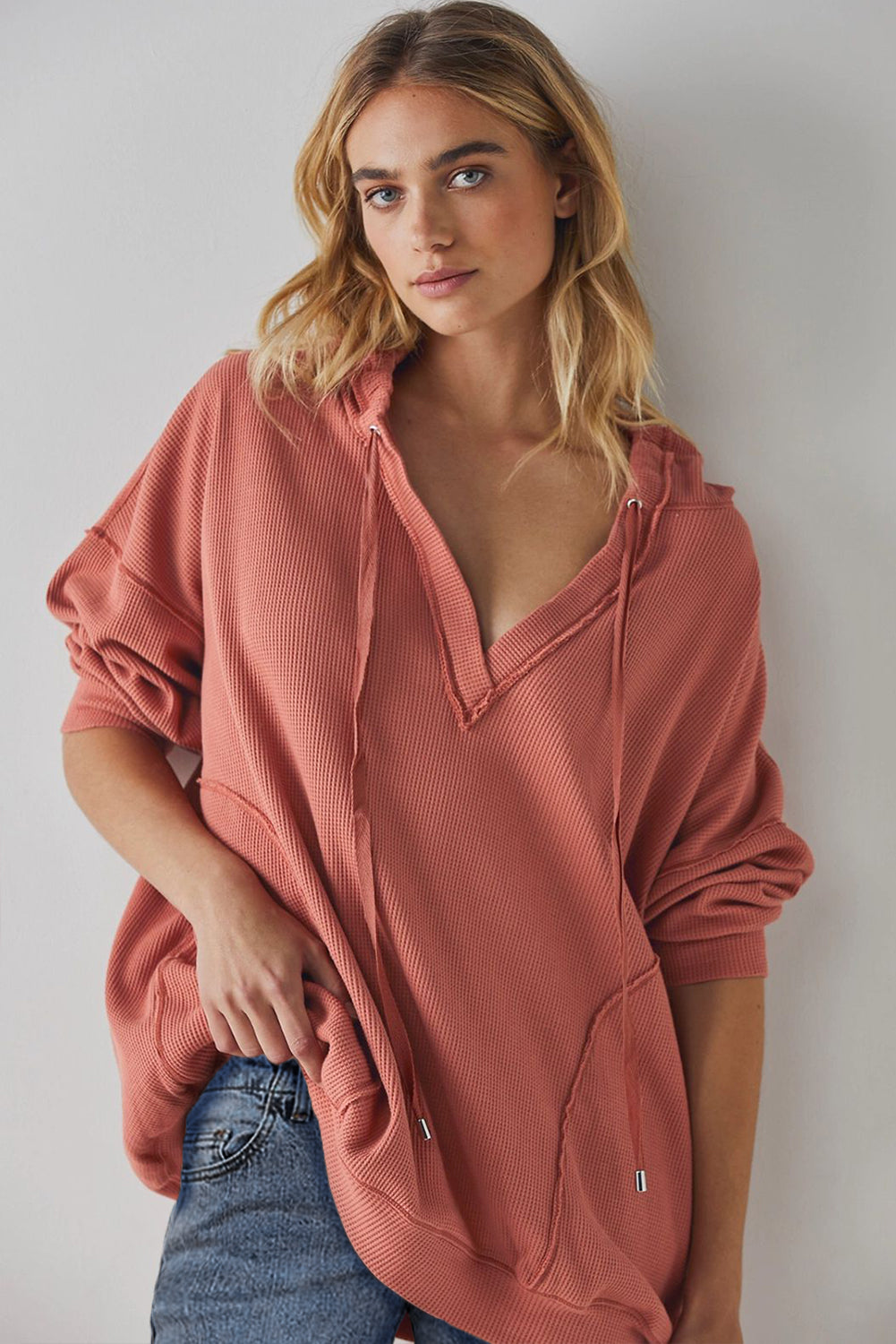 Exposed seam drawstring long sleeve hoodie.