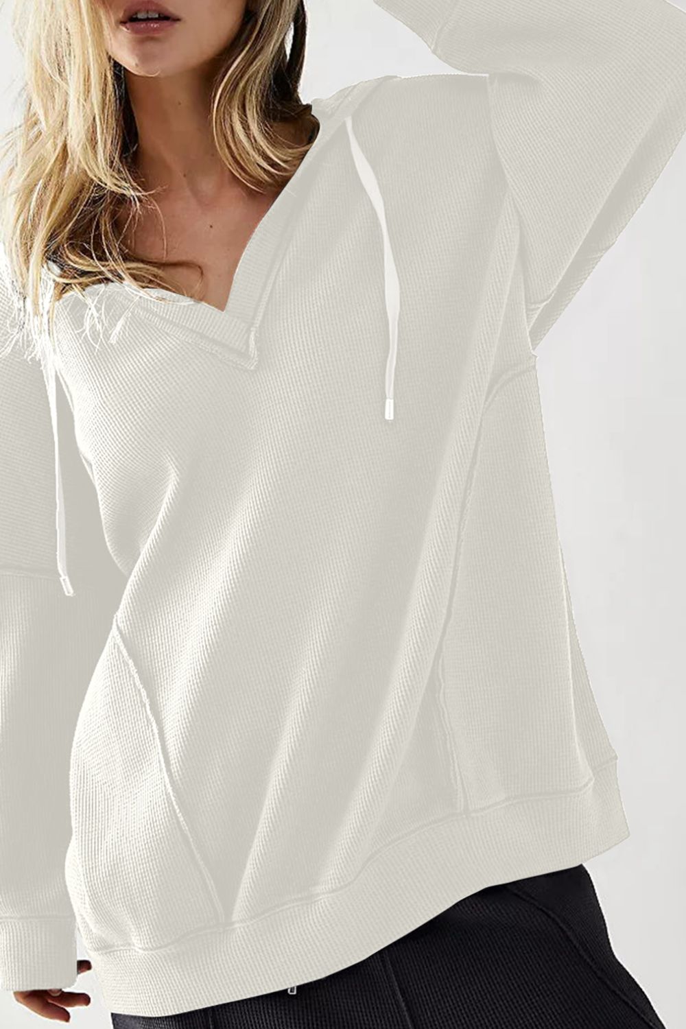 Exposed seam drawstring long sleeve hoodie.