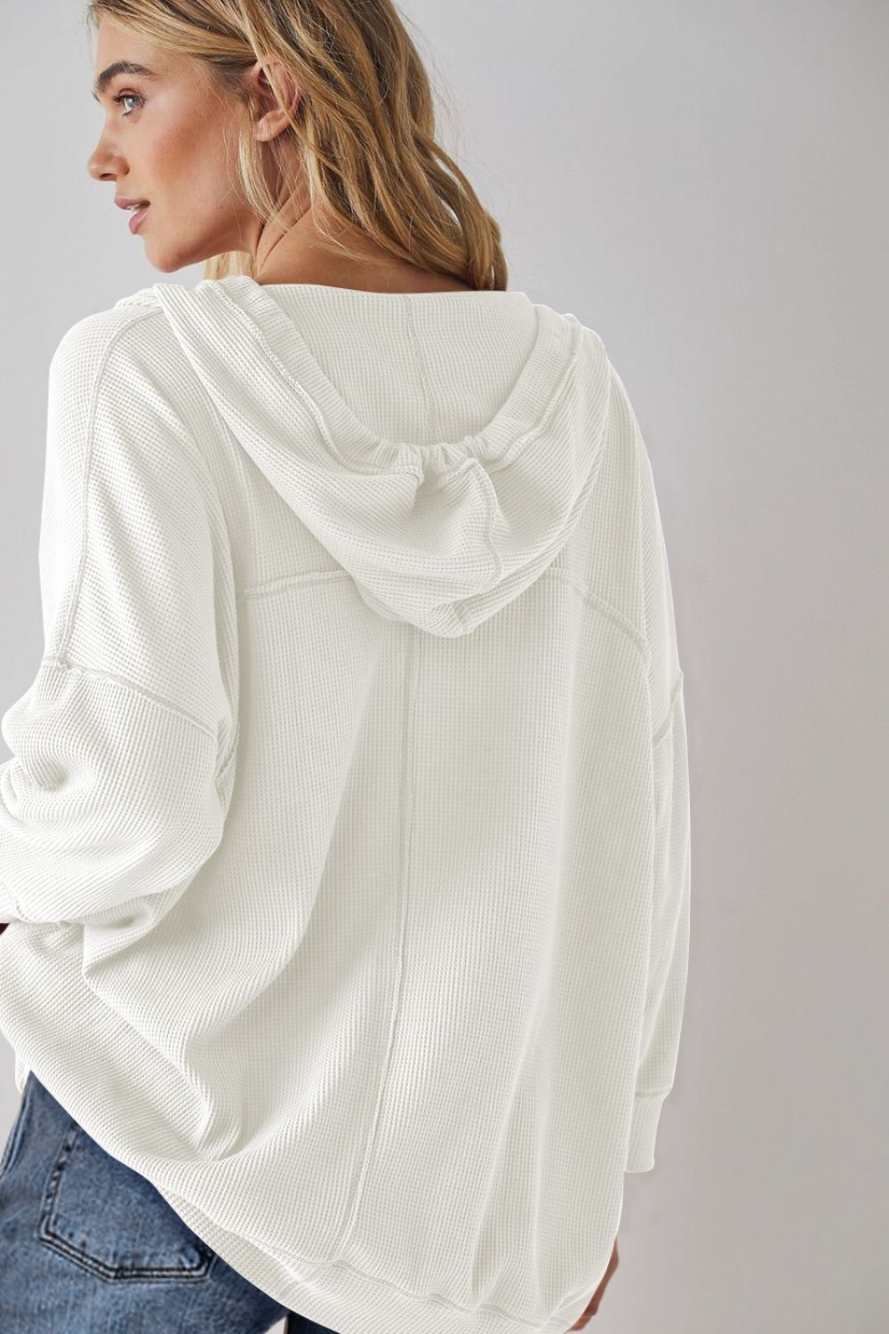 Exposed seam drawstring long sleeve hoodie.
