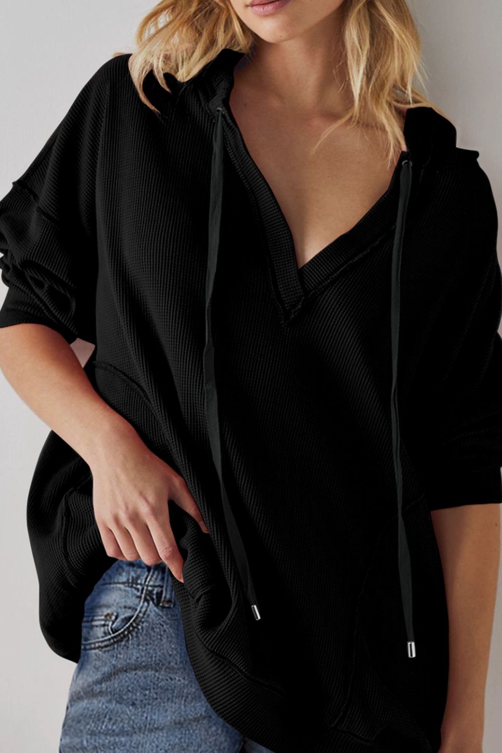 Exposed seam drawstring long sleeve hoodie.