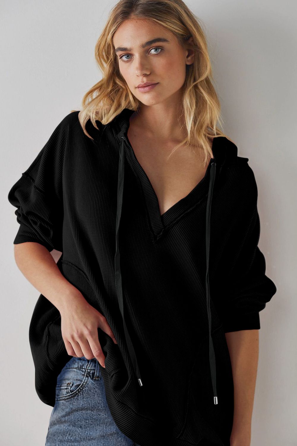 Exposed seam drawstring long sleeve hoodie.