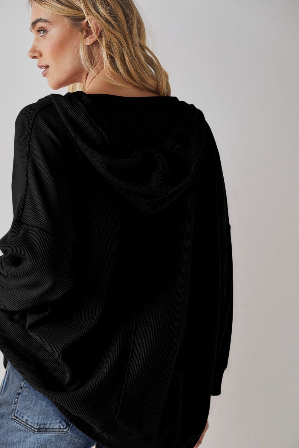 Exposed seam drawstring long sleeve hoodie.