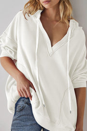 Exposed seam drawstring long sleeve hoodie.