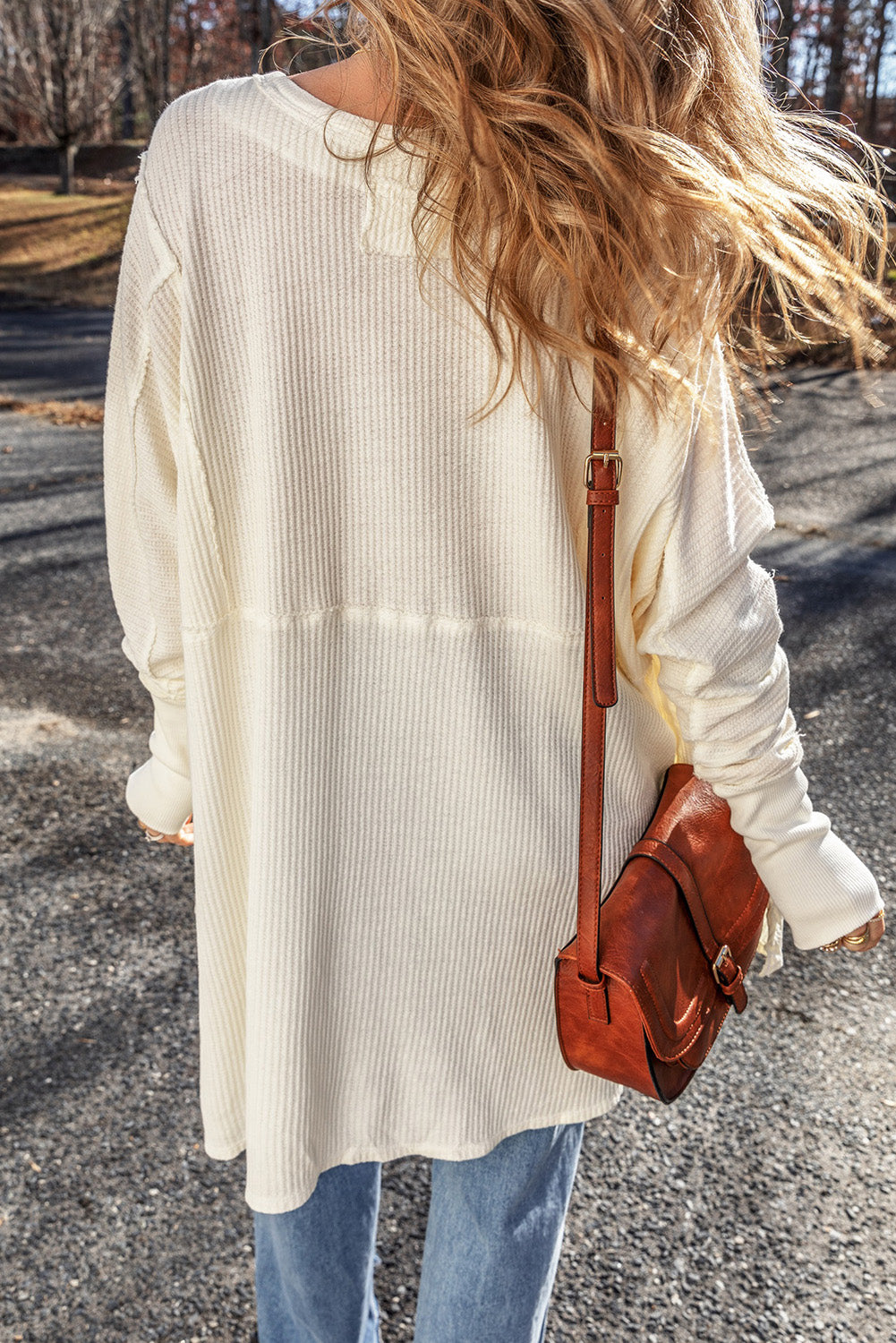 Exposed seam round neck long sleeve blouse.