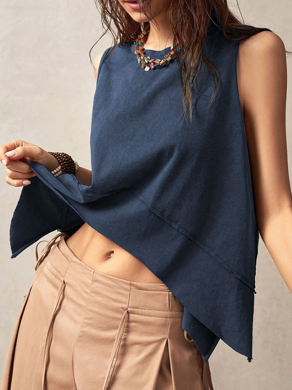 Exposed seam side slit round neck tank, opaque and slightly stretchy.