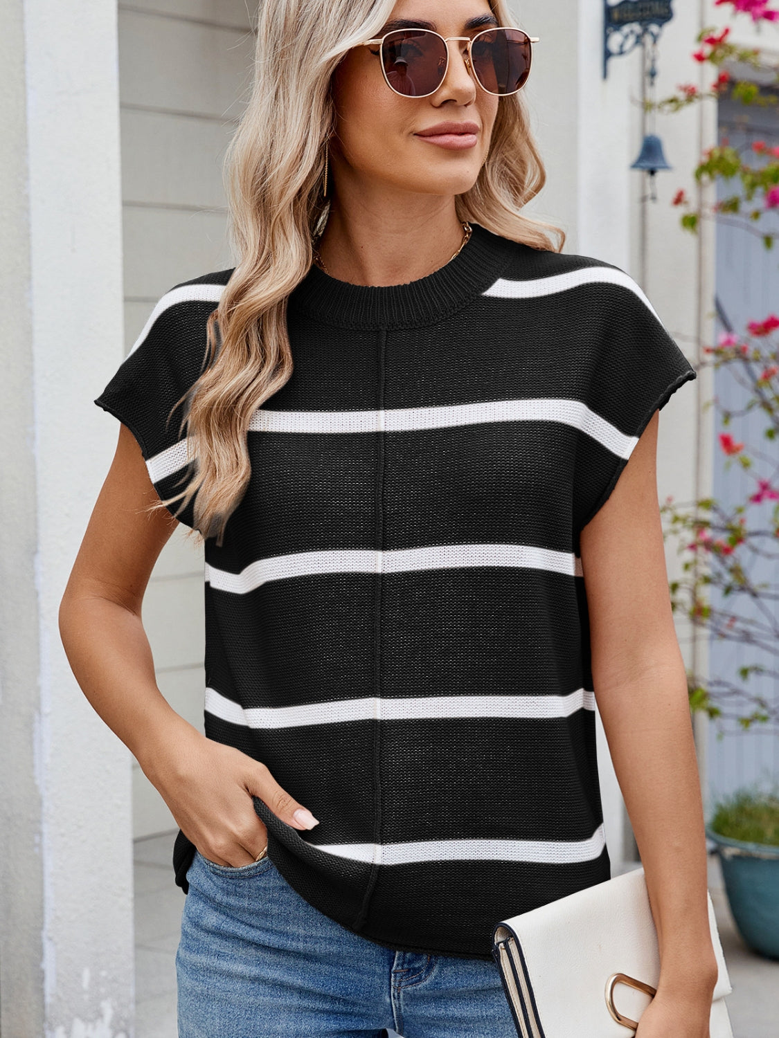 Exposed seam contrast striped round neck knit top.