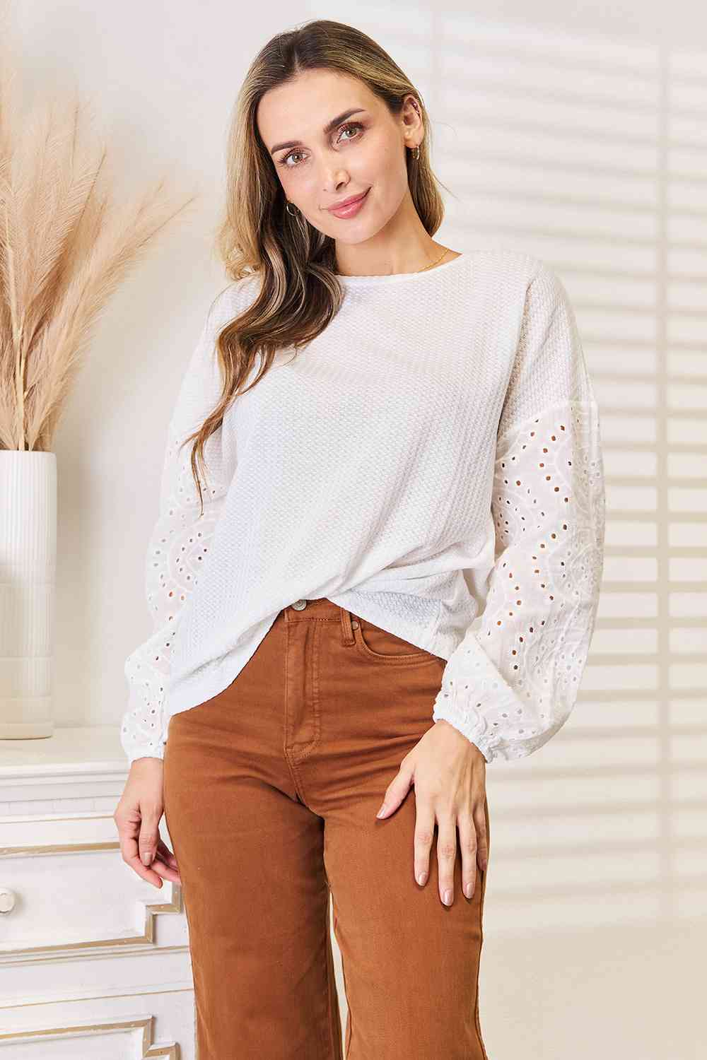Shiny eyelet dropped shoulder round neck blouse.