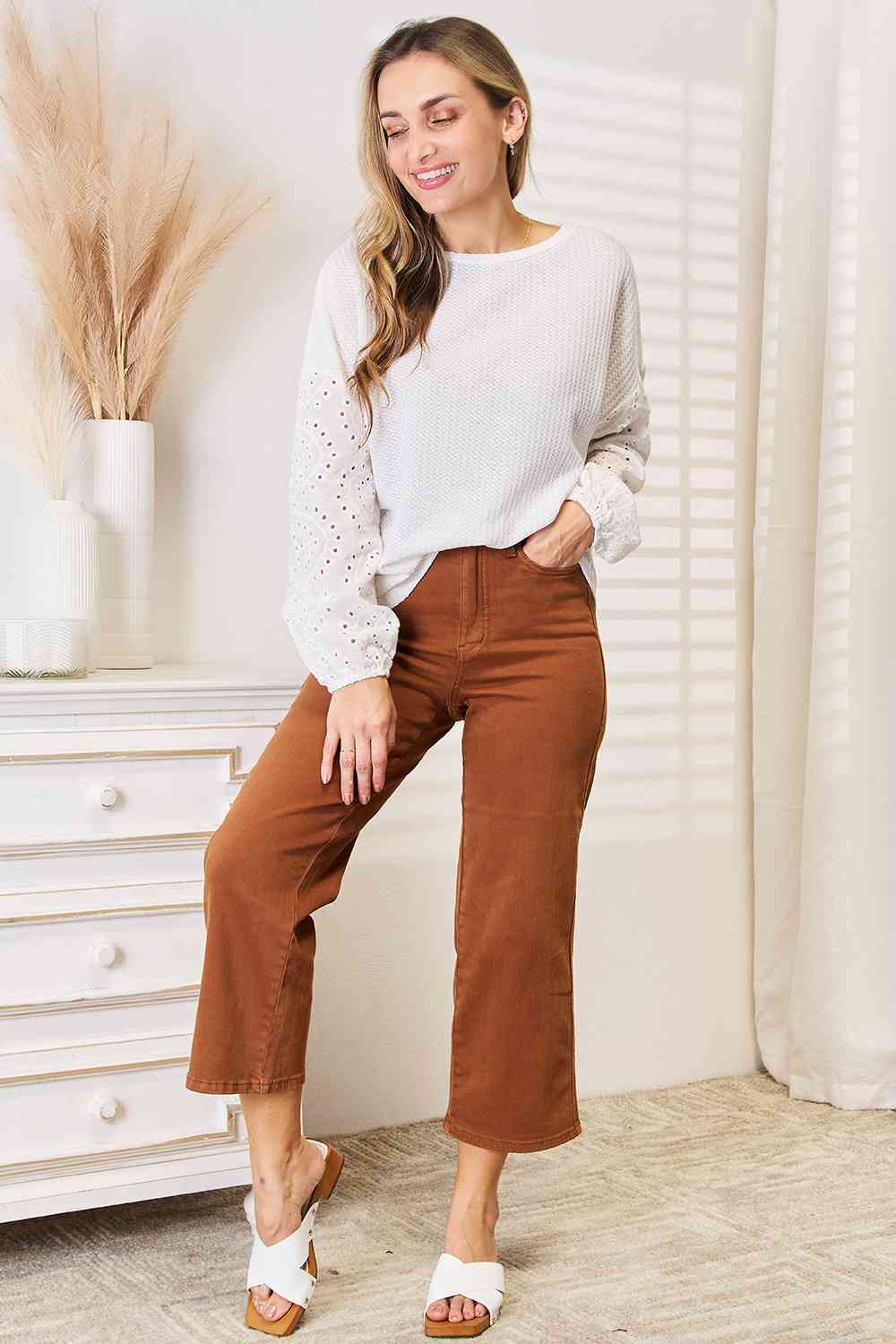 Shiny eyelet dropped shoulder round neck blouse.