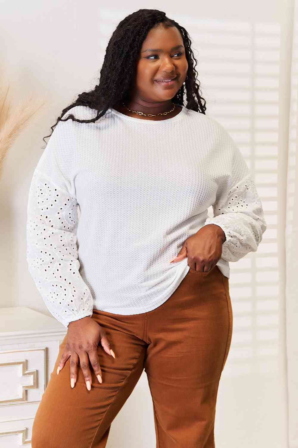 Shiny eyelet dropped shoulder round neck blouse.