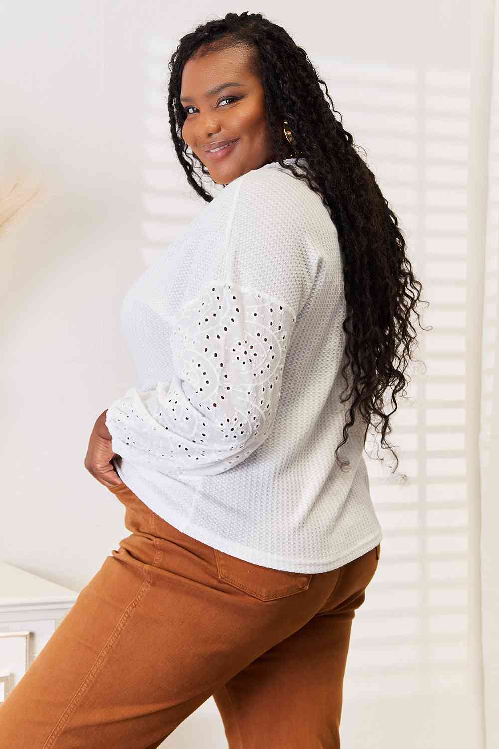 Shiny eyelet dropped shoulder round neck blouse.