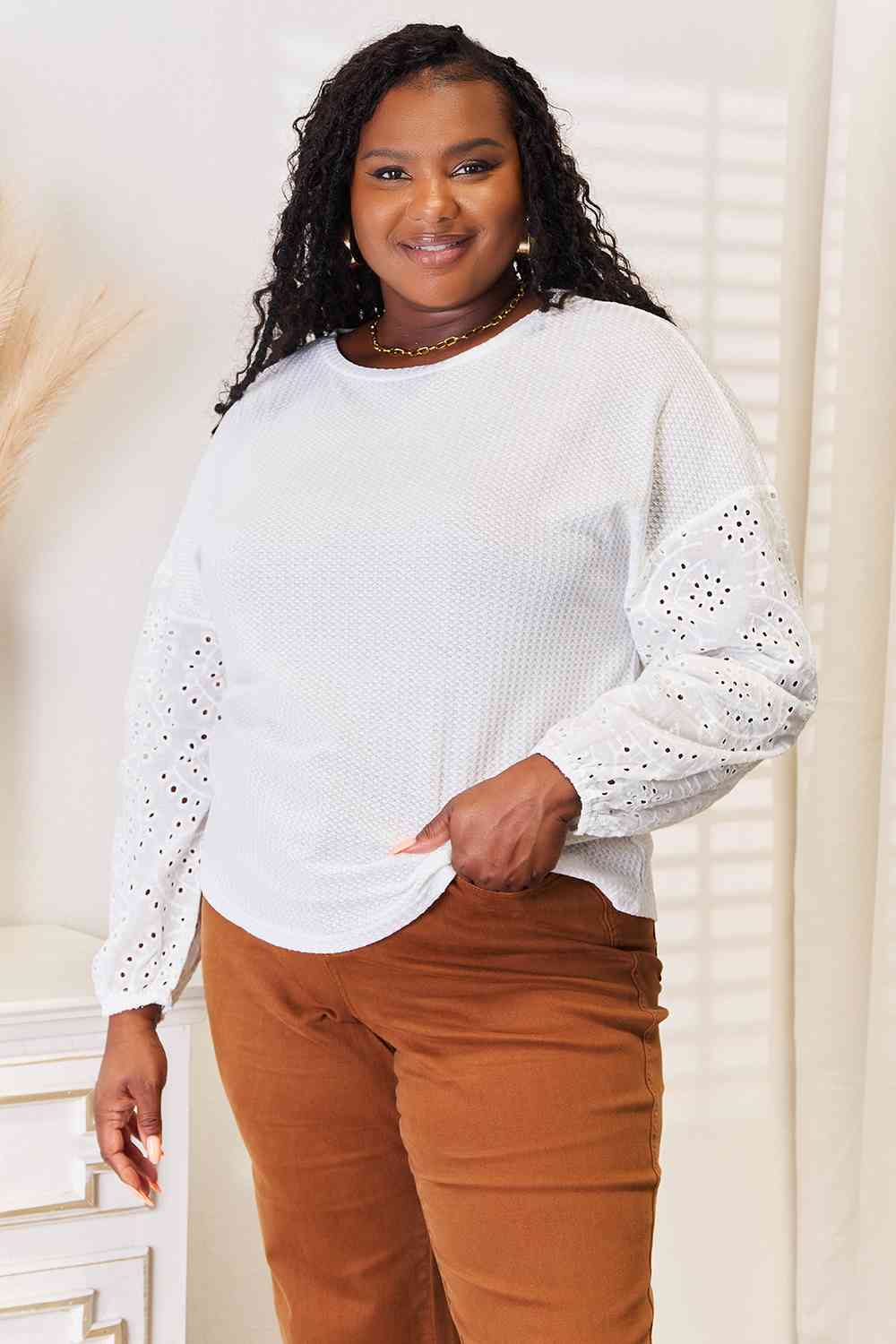 Shiny eyelet dropped shoulder round neck blouse.