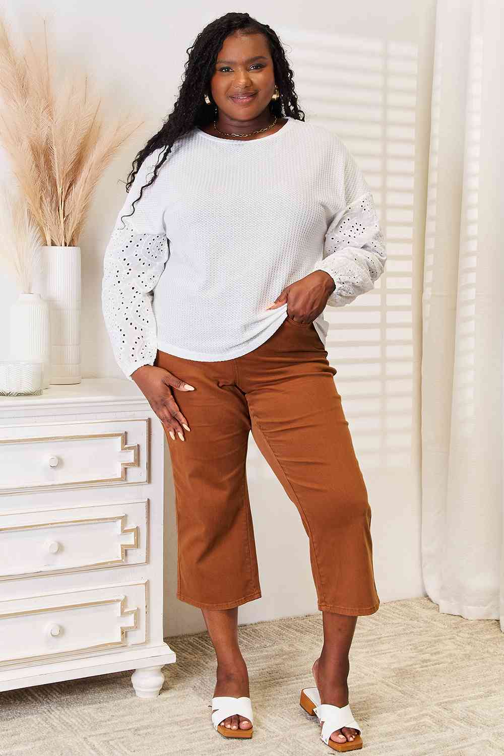 Shiny eyelet dropped shoulder round neck blouse.