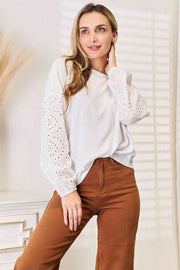 Shiny eyelet dropped shoulder round neck blouse.