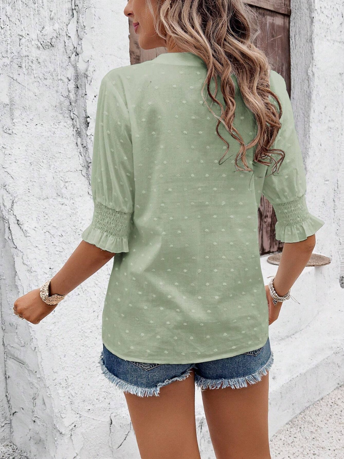 Eyelet notched flounce sleeve blouse.