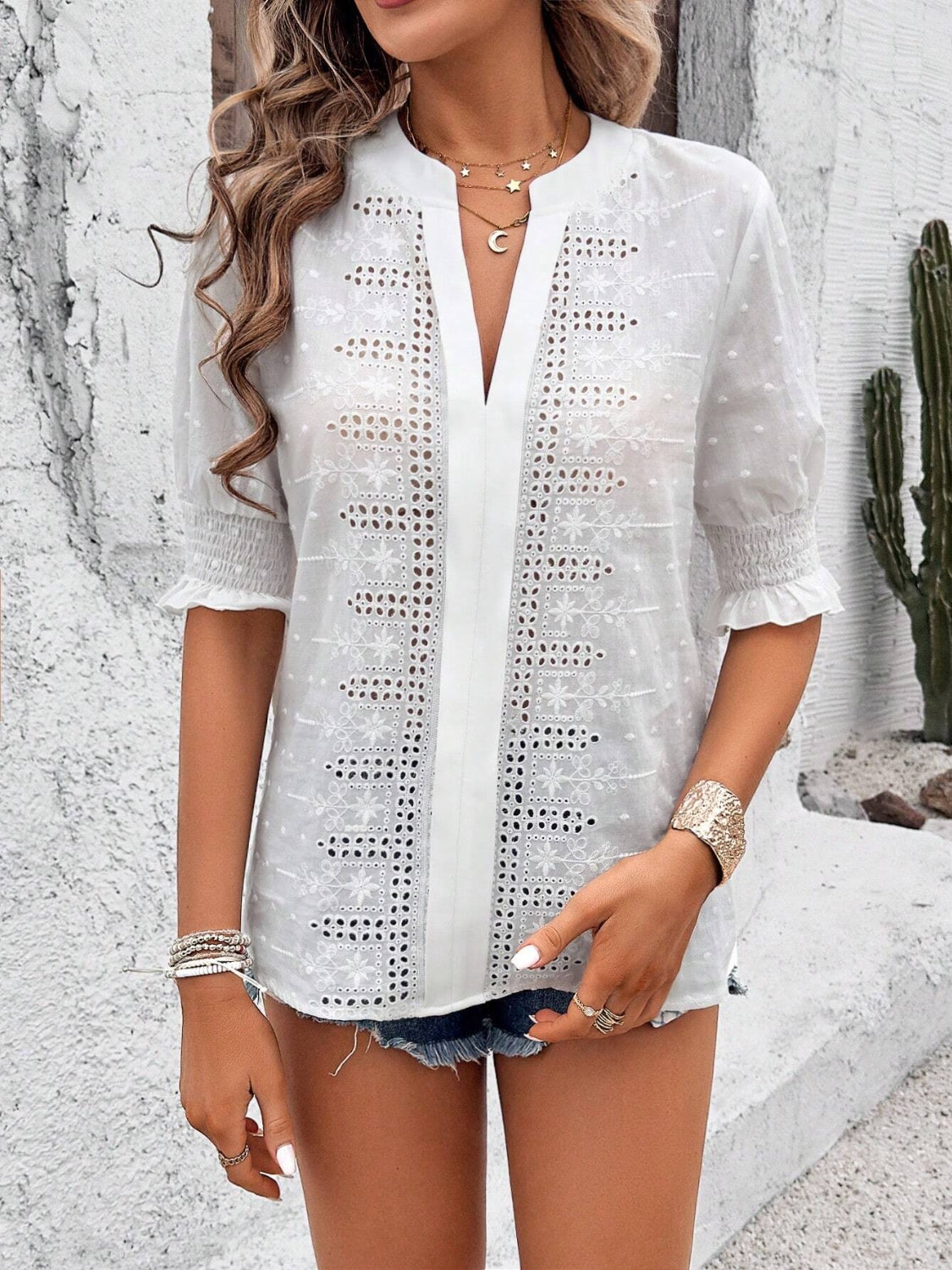 Eyelet notched flounce sleeve blouse.