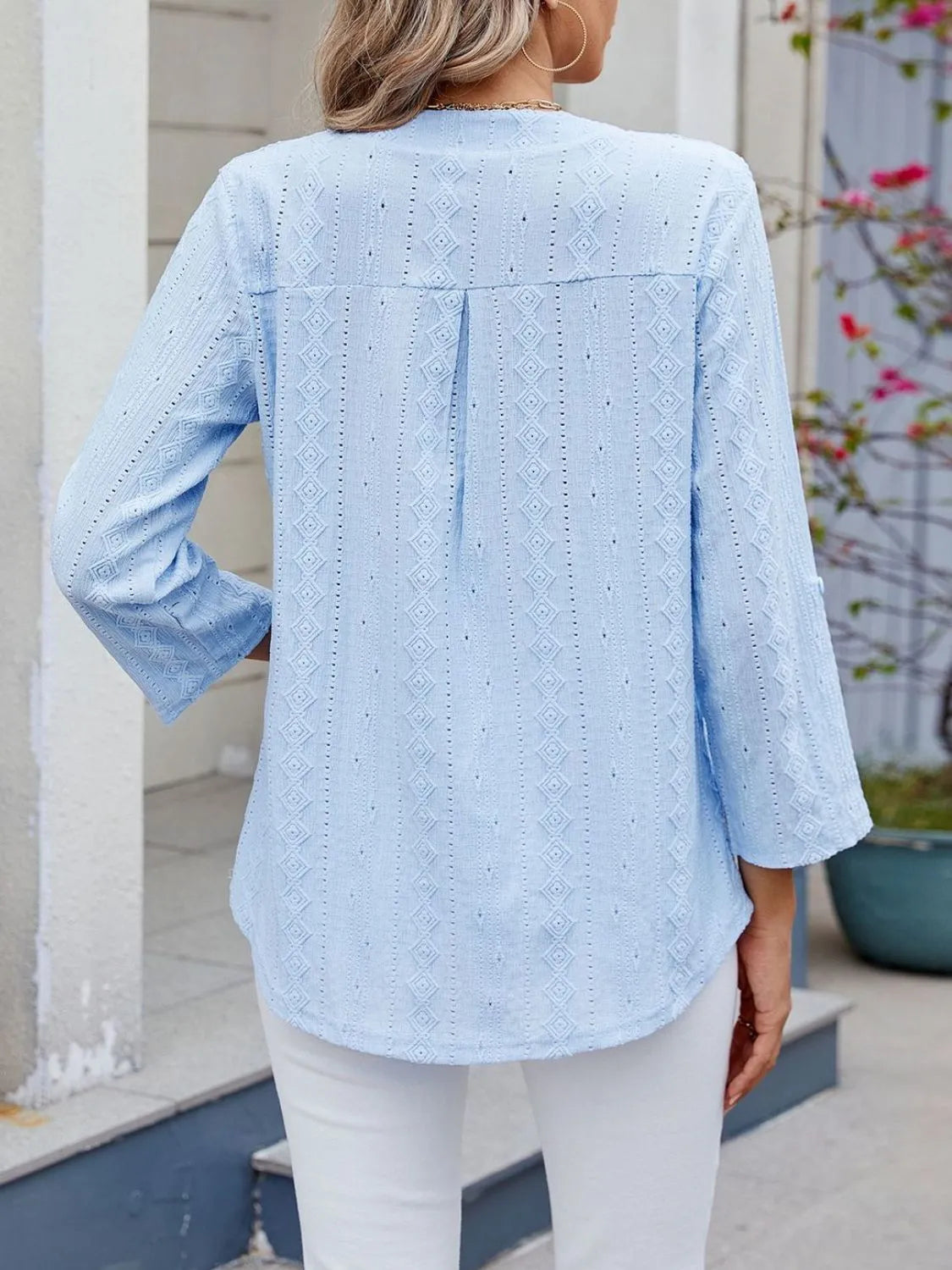 Eyelet notched roll-tab sleeve top.