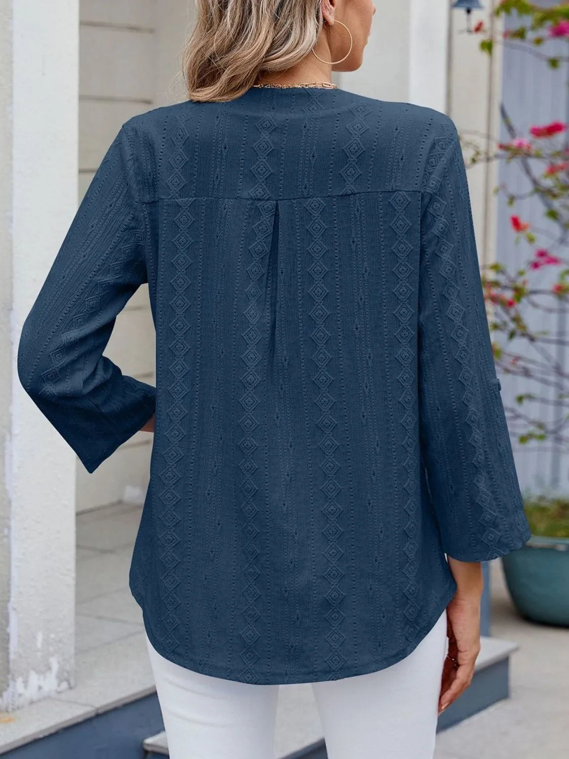 Eyelet notched roll-tab sleeve top.