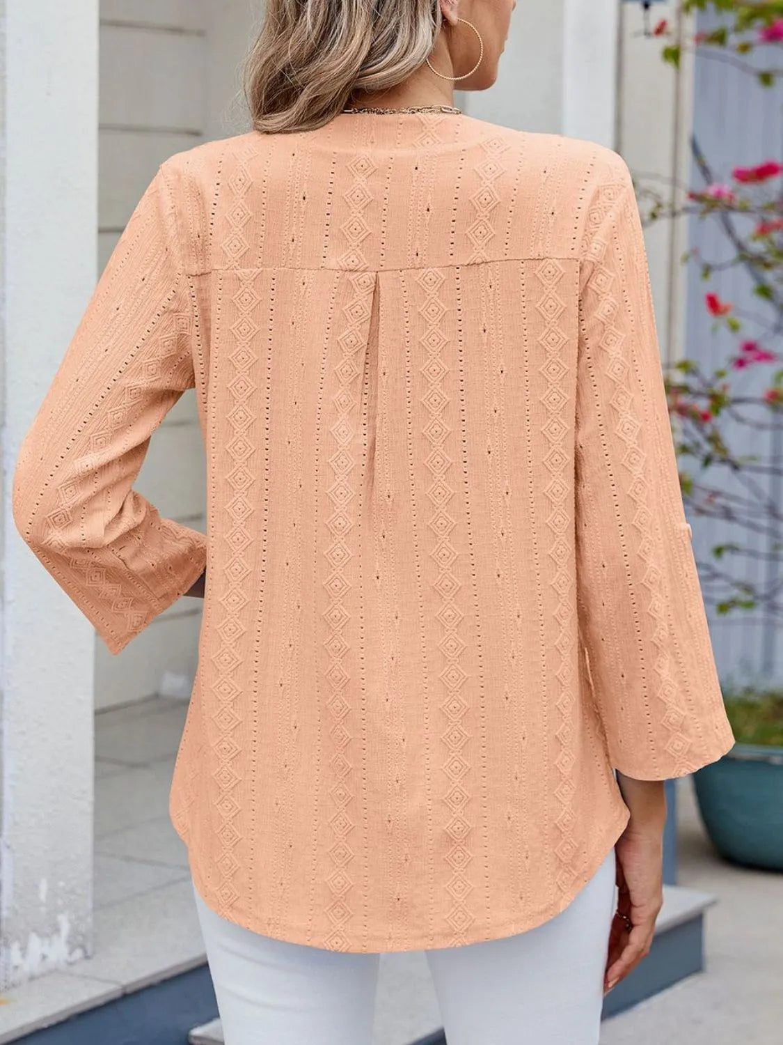 Eyelet notched roll-tab sleeve top.