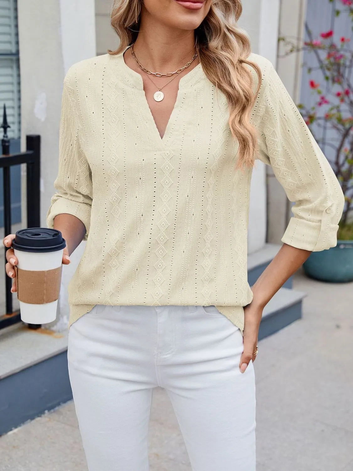 Eyelet notched roll-tab sleeve top.