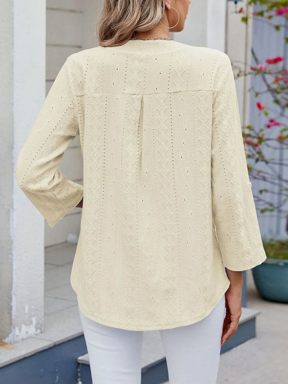 Eyelet notched roll-tab sleeve top.
