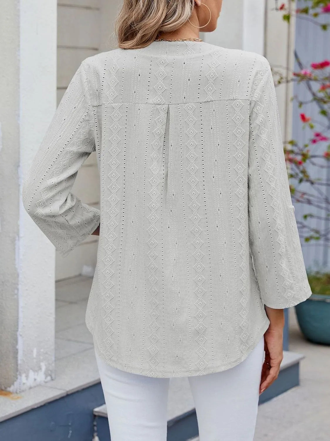 Eyelet notched roll-tab sleeve top.