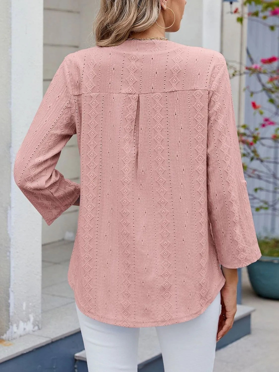 Eyelet notched roll-tab sleeve top.