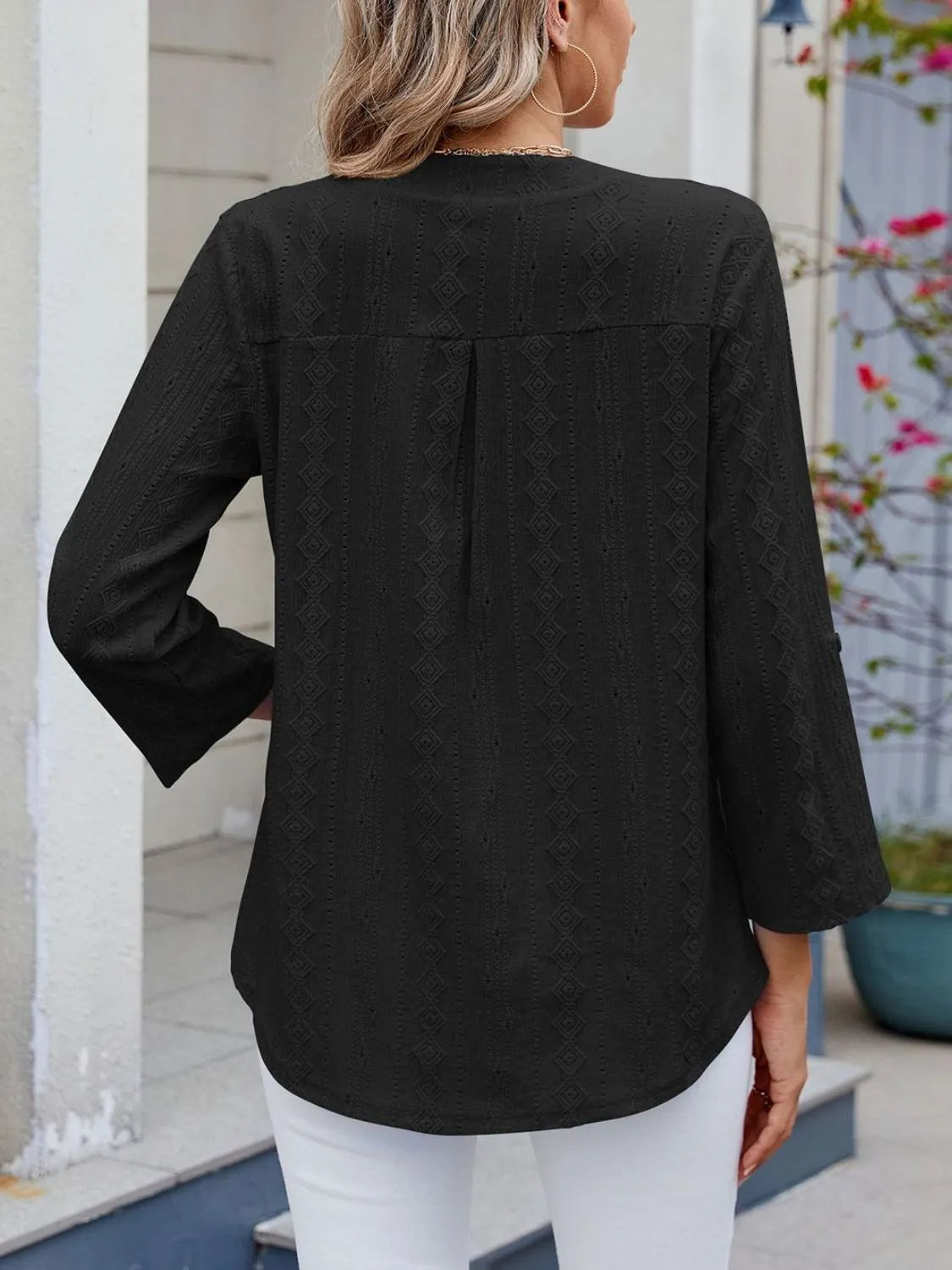 Eyelet notched roll-tab sleeve top.