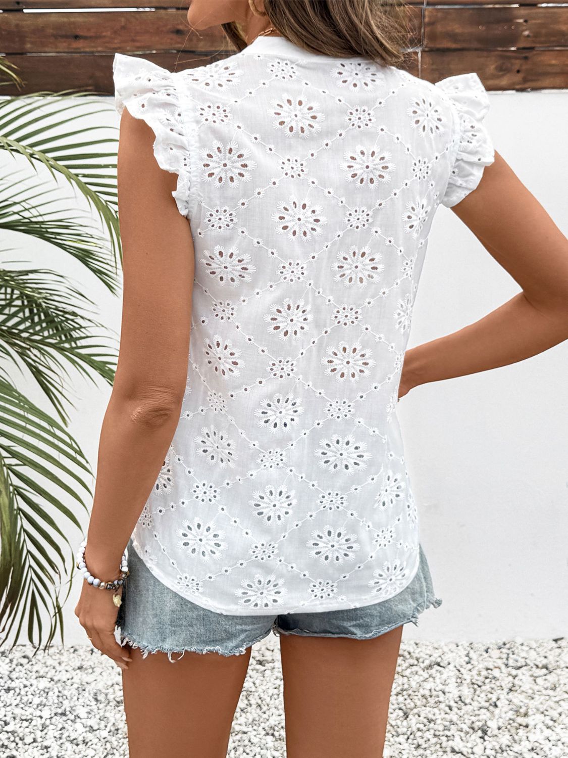 Perfee eyelet notched ruffled cap sleeve blouse with buttons.