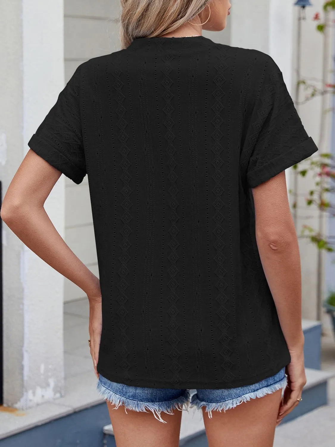 Eyelet notched short sleeve top.