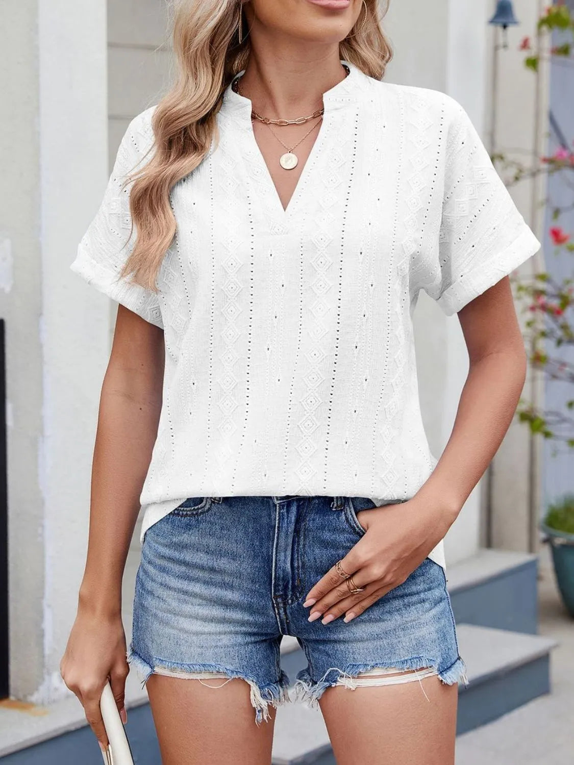 Eyelet notched short sleeve top.