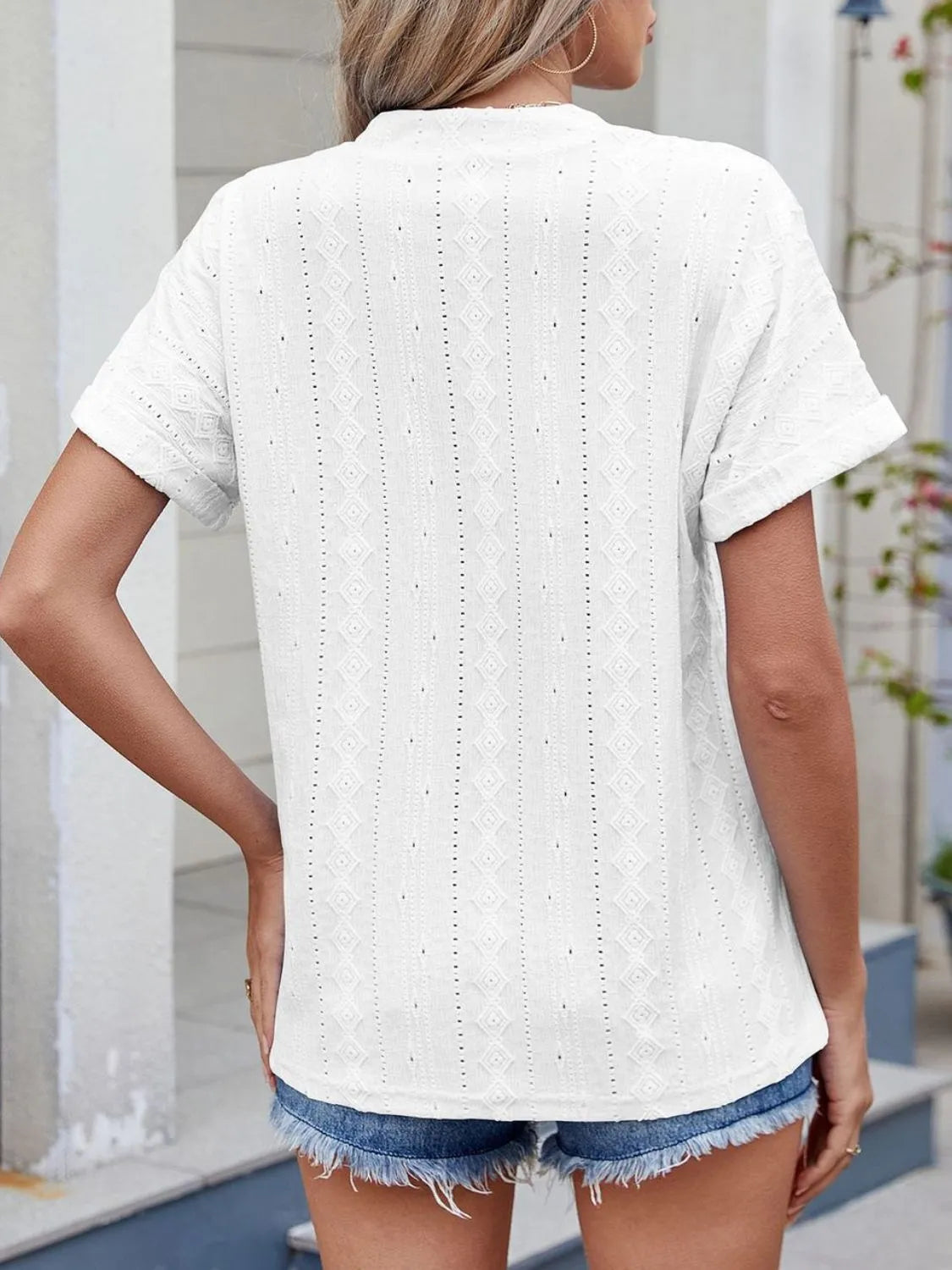 Eyelet notched short sleeve top.