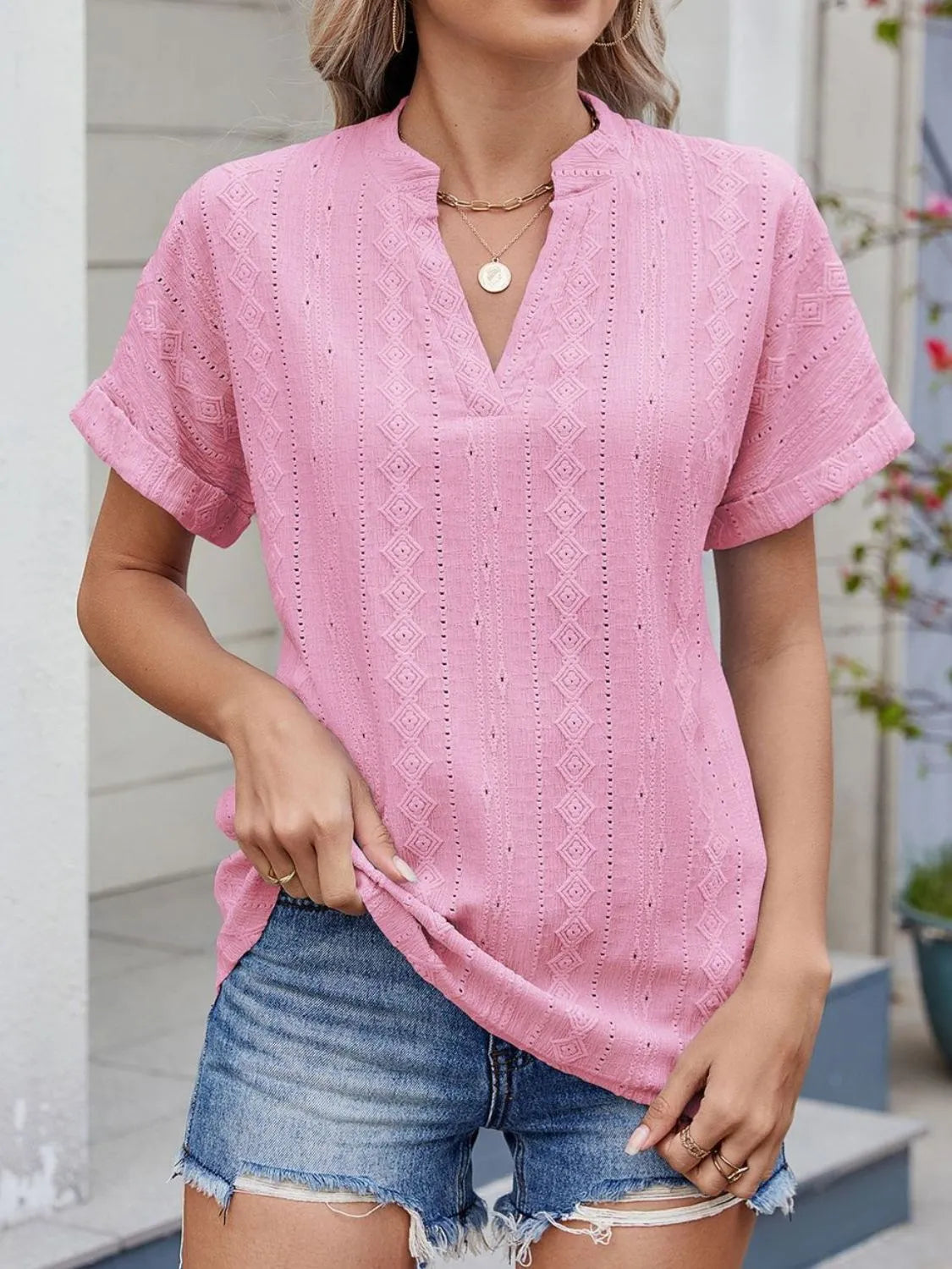 Eyelet notched short sleeve top.