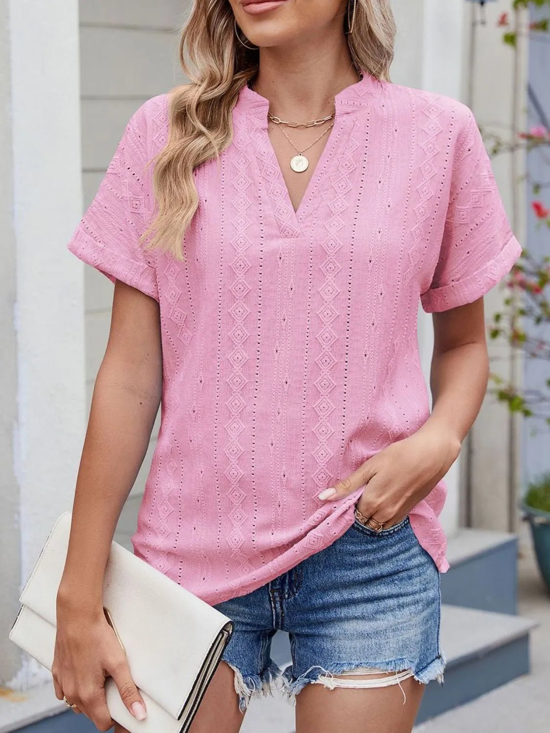 Eyelet notched short sleeve top.