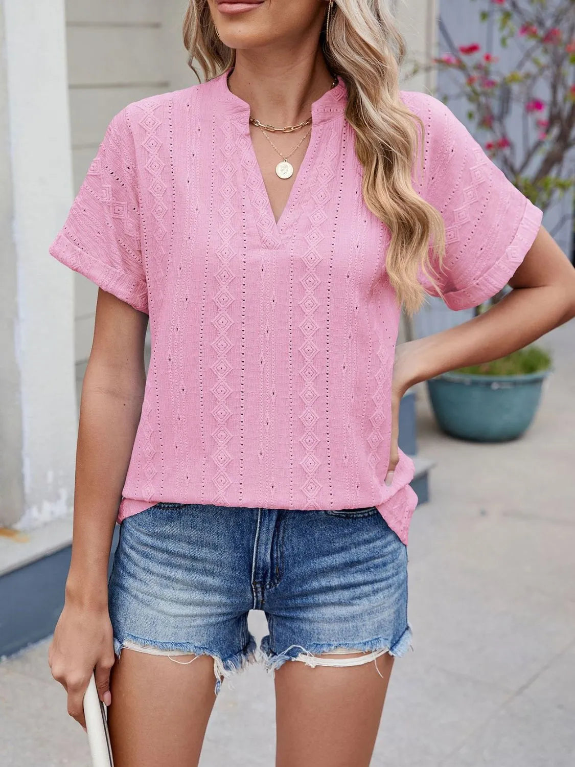 Eyelet notched short sleeve top.