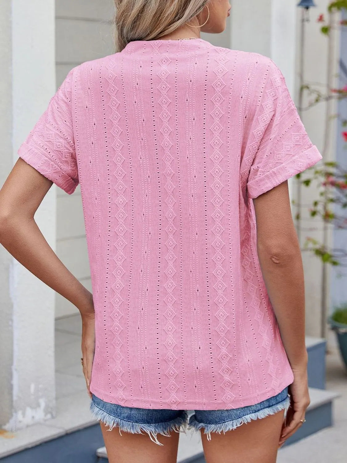 Eyelet notched short sleeve top.